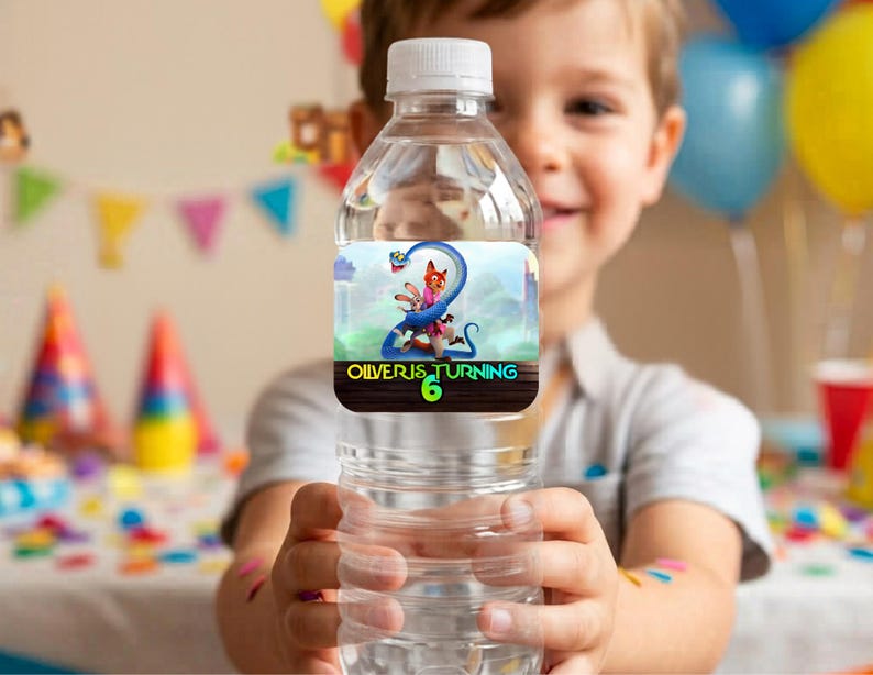 Close up of a hand holding a clear water bottle wrapped in a custom printed Zootopia 2 birthday label. The personalized wrapper reads Happy Birthday Caleb with vibrant colors and high-quality character graphics, demonstrating the final assembled DIY party favor.