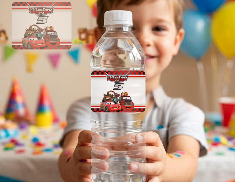 A young boy smiling while holding up a clear water bottle featuring a custom red cartoon racing car label that reads "Mateo is 5". The background shows a blurry kid's birthday party with colorful balloons and party hats. This editable template creates a personalized printable water bottle label for custom race track themed boys birthday party decorations.