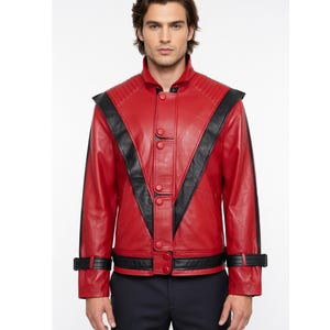 May include: A red leather jacket with black detailing. The jacket has a high collar, shoulder panels, and black stripes on the sleeves. It fastens with buttons and has a tailored fit, offering a striking and fashionable appearance.