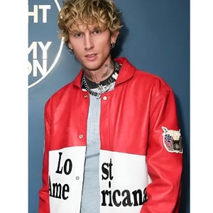 May include: A red and white jacket with the words "Lost Americana" printed on the front. The jacket has a patch with an American flag design on the sleeve. The person in the image is wearing a silver chain necklace and earrings.