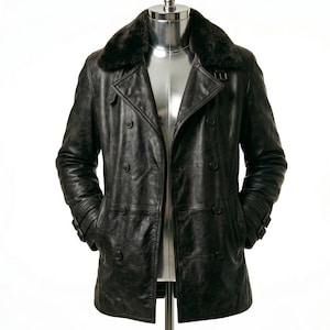 May include: A dark brown leather coat with a faux fur collar. The double-breasted coat features two rows of buttons, side pockets, and adjustable cuffs. The coat is displayed on a mannequin.