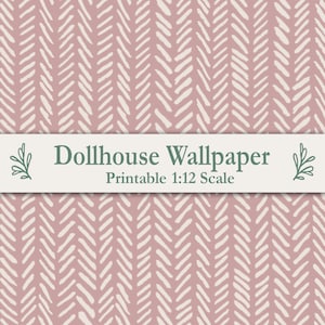 May include: A dusty rose wallpaper pattern featuring a repeating white herringbone design. A horizontal white banner across the center displays the text "Dollhouse Wallpaper" and "Printable 1:12 Scale" in dark green, flanked by small green leaf icons.