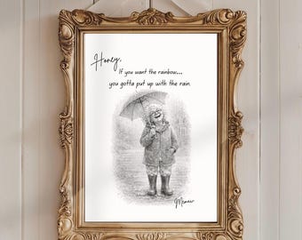 Puede incluir: Una impresión enmarcada con un marco dorado adornado y una cinta blanca. La impresión presenta una ilustración en blanco y negro de una persona bajo un paraguas, con el texto "Honey, If you want the rainbow... you gotta put up with the rain."