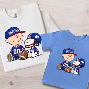 two t-shirts with cartoon characters wearing football uniforms and hats.