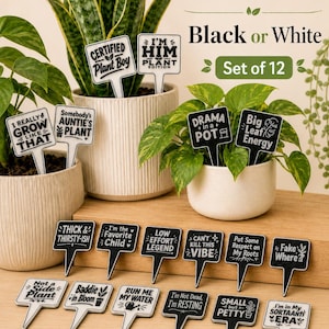 May include: A set of 12 plant markers in black or white with various humorous phrases like Certified Plant Boy, Drama in a Pot, and Big Leaf Energy. These square-shaped stakes feature bold text and small graphic icons, designed to be inserted into soil.