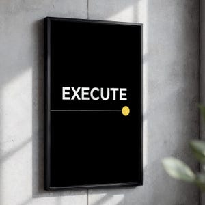 May include: A rectangular wall art piece featuring a black background with the white text EXECUTE centered in the upper portion. A thin horizontal white line extends from the left side to a solid yellow circle positioned on the right side.