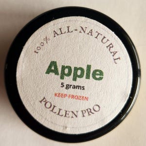 May include: A white ceramic mug with a black handle and the text "But First, Coffee" in a bold, black font. The mug is set against a blurred background, suggesting a cozy setting.