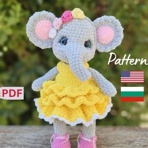 May include: Crocheted elephant doll in gray, yellow, and pink. The elephant has large gray ears with pink centers, blue eyes, and a yellow dress with white trim. The doll is wearing pink shoes and a floral headpiece. The word "Pattern" is visible.