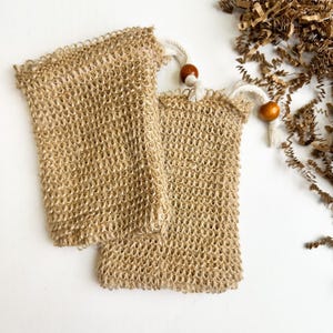 May include: A set of three ceramic mugs with a speckled, matte finish. The mugs are in shades of cream, light gray, and dark gray. Each mug has a simple, minimalist design and a rounded handle.