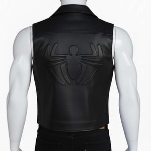 Back view of men's black leather vest — large 3D embossed spider logo in tonal black on genuine leather, motorcycle biker vest back detail