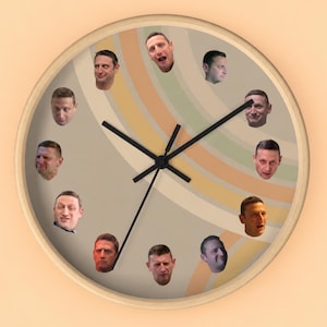 May include: A round wall clock with a light wood frame and a beige face featuring curved, muted-coloured stripes. Twelve distinct photographic portraits of the same person with varying facial expressions are arranged around the dial as hour markers.