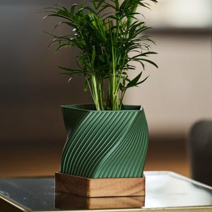 May include: A white ceramic mug with a black handle and the text "But first, coffee" in a handwritten style. The mug is on a white surface. The mug is 4 inches tall.