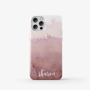 Puede incluir: Una funda de tel&eacute;fono de acuarela rosa y blanca con el nombre "sharon" escrito en cursiva blanca con un coraz&oacute;n a cada lado del nombre.