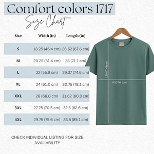 May include: A sage green Comfort Colors 1717 t-shirt hangs on a wooden hanger. The image includes a size chart with measurements in inches and centimeters for sizes S through 4XL. Text at the top reads "Comfort Colors 1717 Size Chart."