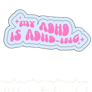 May include: A die-cut sticker featuring the pink text "MY ADHD IS ADHD-ING" in a bubbly, rounded font. The text is surrounded by a light blue cloud-like border and accented with small pink four-pointed star shapes on the left and right sides.
