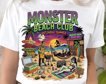 May include: A white t-shirt featuring a colorful graphic of a beach scene with monsters. The text reads Monster Beach Club, Hot Ghoul Summer, Mummy Wrap, Dracula Cape, Swamp Mud, Ecto-Cooler, Monster Mash Beach Bar, and Spooky Beach Vacation.