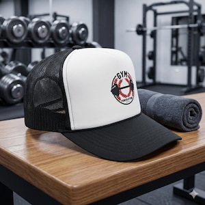 May include: Black and white trucker hat with a white front panel featuring a "GYM POWERLIFTING" logo in a circular design. The logo includes a barbell and red accents. The hat has a black brim and mesh back, suitable for gym enthusiasts.