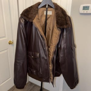 May include: A set of three ceramic mugs with a speckled, matte finish. The mugs are in shades of cream, light gray, and dark gray. Each mug has a simple, minimalist design, perfect for coffee or tea.