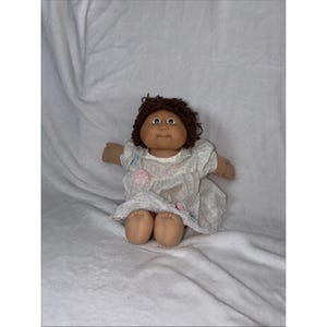 May include: A set of three ceramic mugs with a speckled, matte finish. The mugs are in shades of cream, light gray, and dark gray. Each mug has a simple, minimalist design, perfect for coffee or tea.