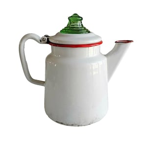 May include: White enamel teapot with a green glass lid and a red rim. The teapot has a curved handle and a spout. A vintage kitchenware item.