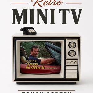 May include: A beige retro-style mini television with a black frame and a small black telephone on top. The screen displays an image of Tom Selleck in a red car with the text Starring Tom Selleck as Magnum. The words Retro MINI TV and TOUCH SCREEN appear.