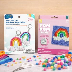 May include: Two craft kits are shown: one for making rainbow keychains and another for creating art with pom-poms. The keychain kit contains materials to create two rainbow keychains. The pom-pom kit features a rainbow design and includes adhesive canvas and pom-poms.