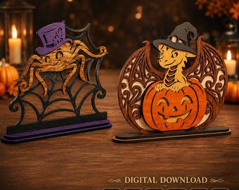 May include: Two laser-cut wooden Halloween decorations on stands. One features a brown spider wearing a purple top hat on a black web. The other shows a brown dragon wearing a black witch hat inside an orange jack-o'-lantern. Text reads DIGITAL DOWNLOAD.