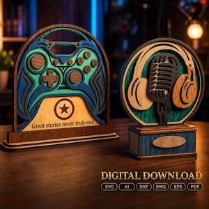 May include: Two layered wooden signs featuring a blue and teal gaming controller with the text Great stories never truly end and a circular sign with a black microphone and tan headphones. The image includes the text DIGITAL DOWNLOAD SVG AI DXF DWG EPS PDF.