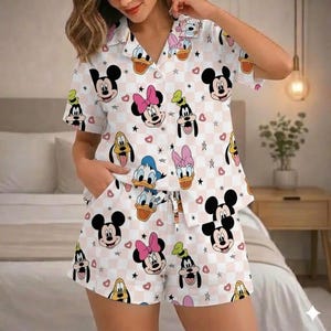 May include: A set of three ceramic mugs with a speckled, cream-colored glaze. Each mug features a different hand-painted floral design in shades of blue, green, and yellow. The mugs have a simple, rounded shape and a comfortable handle.