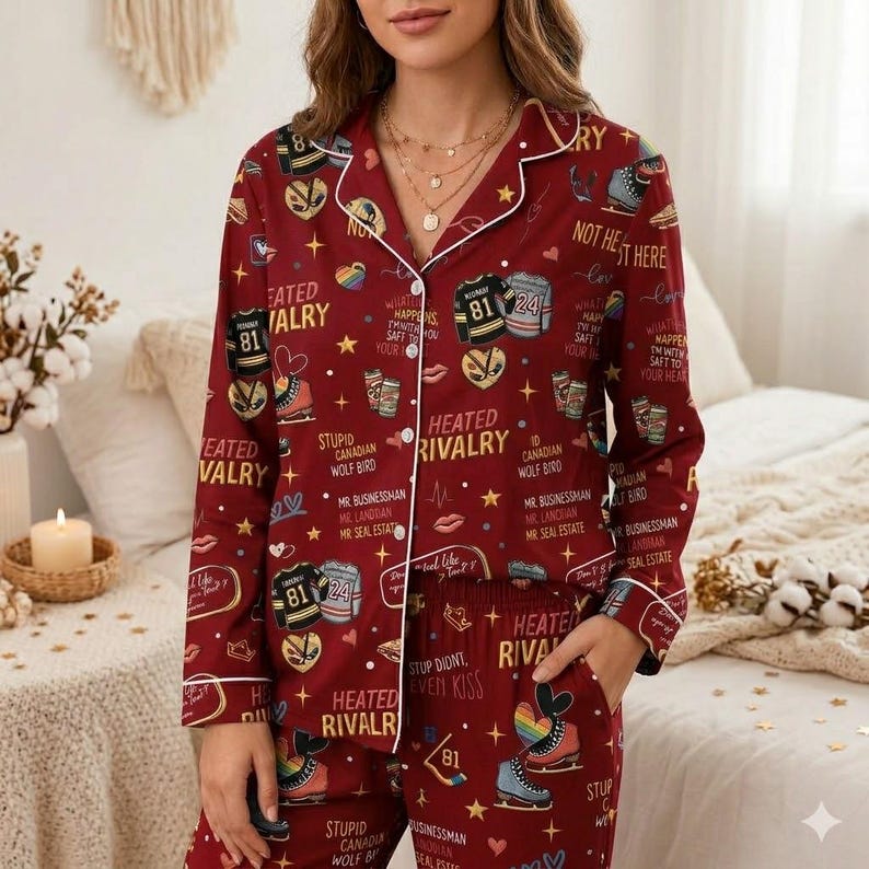 May include: Burgundy pajama set with white trim, featuring a repeating pattern of hockey skates, jerseys, and text. The text includes phrases like "Heated Rivalry" and "Stupid Canadian Wolf Bird".
