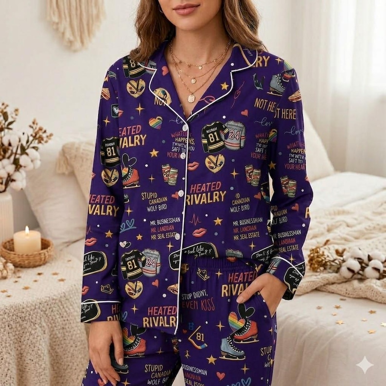 May include: Purple pajama set with a white trim, featuring a pattern of ice skates, hockey jerseys, and text. The text includes phrases like "Heated Rivalry" and "What Happens SafT to Your Heart".