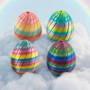 May include: Four multi-coloured, striped egg-shaped objects in shades of pink, yellow, green, blue, and purple. Each egg has a decorative top with a scalloped design. The eggs are set against a backdrop of fluffy white clouds and a rainbow.