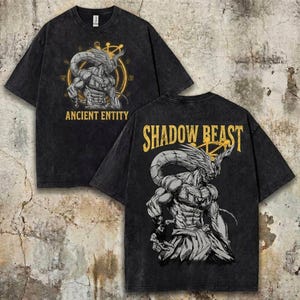 May include: Black t-shirt featuring a detailed illustration of a muscular figure with a horned head and intricate design. The front of the shirt reads "ANCIENT ENTITY" in gold lettering, while the back says "SHADOW BEAST".