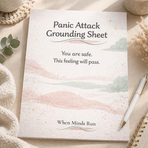 May include: A rectangular paper sheet titled Panic Attack Grounding Sheet with the text You are safe. This feeling will pass. and When Minds Run. The design features soft pink and sage green abstract landscape shapes and small gold stars.