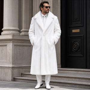 May include: A full-length, white faux fur coat with a wide lapel collar. The coat is worn with white pants and shoes. The person is wearing sunglasses and standing in front of a building with columns and a black door.