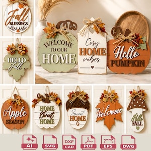 May include: A collection of decorative wooden wall signs featuring autumn themes, including pumpkins, leaves, acorns, and mushrooms. Each sign displays text such as Fall Blessings, Welcome to Our Home, Cosy Home Vibes, Hello Pumpkin, Apple Season, Home Sweet Home, Sweet Home, Welcome, and Hello Fall.