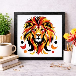 May include: A framed art print featuring a stylized lion's head. The lion's mane is rendered in shades of red, orange, and yellow, with black accents. The artwork is set against a white background and framed in a black square frame. Decorative elements surround the lion.