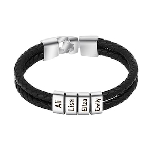 May include: Black braided leather bracelet with silver-tone clasp and four personalized name beads. The names "Ali", "Lisa", "Eliza", and "Emily" are engraved on the beads. A stylish and personalized accessory.