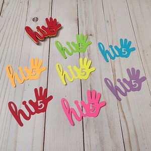 May include: Colorful cutouts spelling "hi 5" in various colors, including red, orange, yellow, green, blue, and purple. The number 5 is incorporated into a hand shape. These are likely for a birthday or celebration.