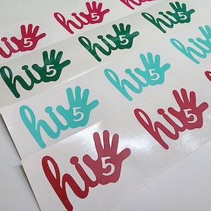 May include: A set of nine hi-five stickers with a handprint and the text "hi 5". The stickers are in three colors: red, teal, and green.