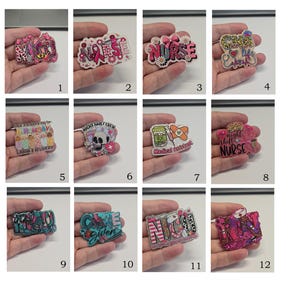 May include: A collection of twelve decorative acrylic badges featuring various medical themes, including NICU, Nurse, CNA Life, and Labor and Delivery, with colourful designs, glitter accents, and medical icons like stethoscopes, pills, and syringes.