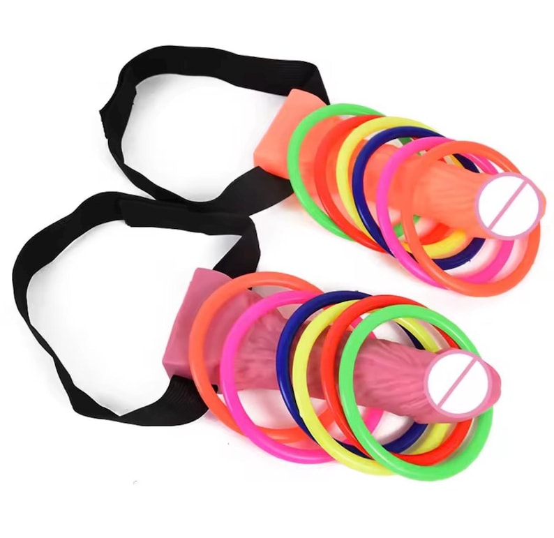 May include: Two sex toys with a pink and orange design, each featuring a series of colorful rings. The toys are connected to black straps. The rings are in various colors, including green, pink, red, yellow, and blue.