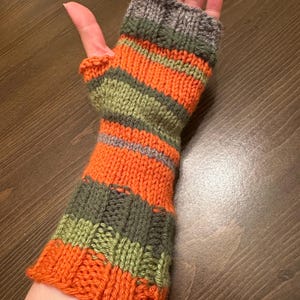 May include: Orange, green, and gray striped fingerless gloves knitted with a textured stitch.