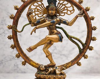 May include: A bronze statue of Shiva Nataraja, the Hindu Lord of Dance. The figure is depicted in a dynamic dancing pose within a circular frame. The statue has multiple arms and detailed features. The base is multi-coloured.