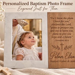 May include: A rectangular photo frame featuring a white marble-patterned left side and a light brown wooden right side. The wood is engraved with the text Jeremiah 29:11, a cross, the name Palmer Elisa, and the date Baptized October 18, 2026.