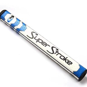 May include: A white and blue SuperStroke golf putter grip. The grip has a white body with blue accents and the words "Super Stroke" in black. The ends are black.