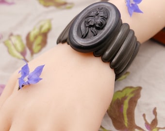 Antique Victorian mourning cuff with vulcanite lozenge beads surrounding genuine carved jet with floral motif