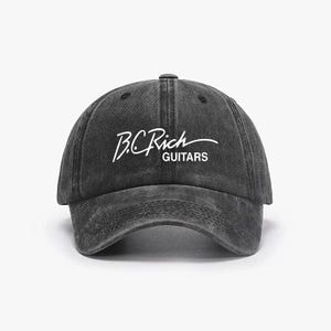 Può includere: Un cappellino da baseball grigio scuro con visiera curva. Il cappellino presenta il testo bianco "B.C. Rich" in un font corsivo sopra la parola "GUITARS". Il cappellino ha un aspetto vintage e usurato.