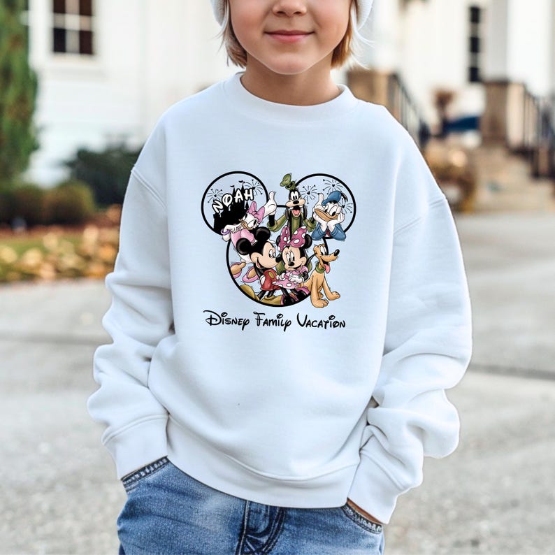 May include: A white ceramic mug with a black handle and the text "But First, Coffee" in a bold, black font. The mug is filled with a dark liquid, likely coffee, and sits on a light-colored surface.