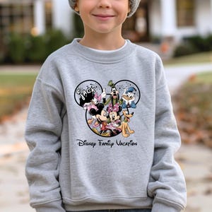 May include: A set of three ceramic mugs with a speckled, matte finish. The mugs are in shades of cream, light gray, and dark gray. Each mug has a simple, minimalist design and a rounded handle. The mugs are likely for coffee or tea.